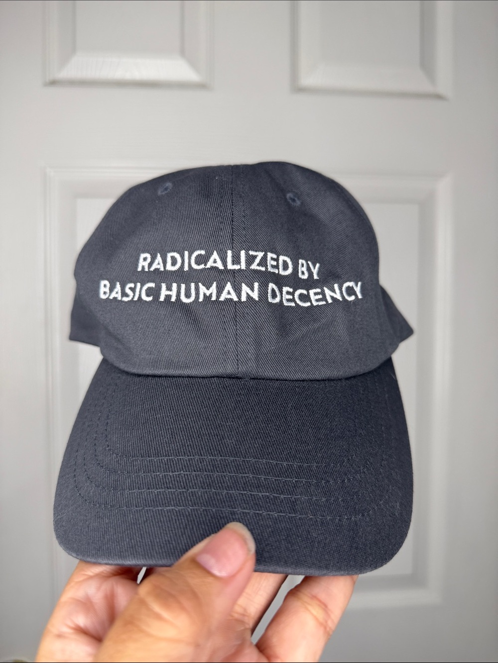 The Classic navy hat with white embroidered slogan